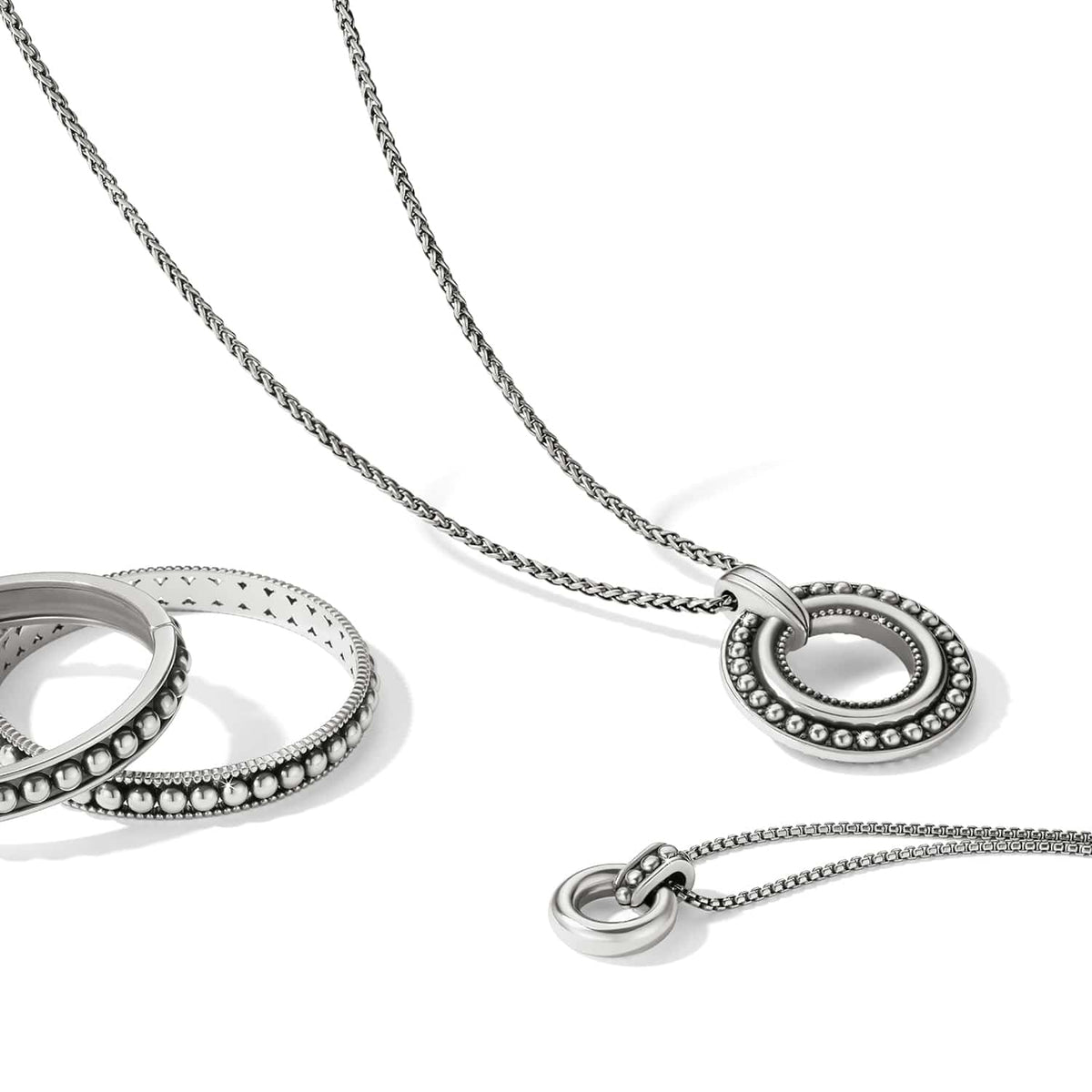 Brighton silver-plated pendant necklace styled with a beaded ring bracelet on a white background