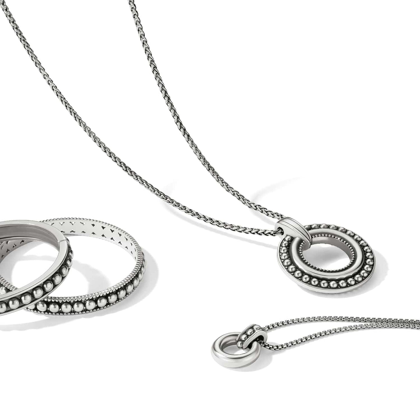 Brighton silver-plated pendant necklace styled with a beaded ring bracelet on a white background