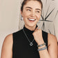 Model wearing a Brighton silver-plated pendant necklace with coordinating Brighton hoop earrings, bracelets, and ring