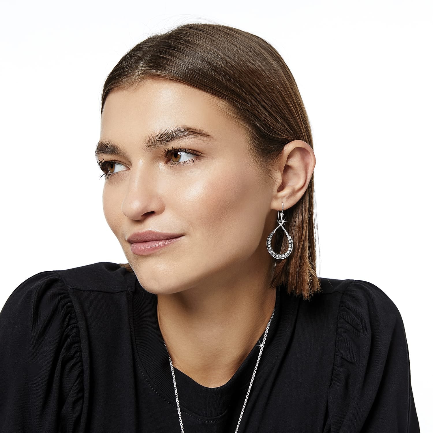 Model wearing a Brighton silver-plated teardrop drop earring with crystal accents along the inner curve