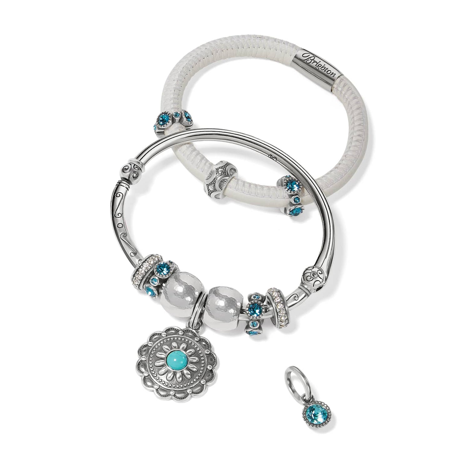 Brighton silver-plated charm bracelets with turquoise dyed howlite flower pendant, crystal accents, and white leather band on white background