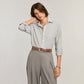 Model wearing a Brighton brown leather belt with ornate silver-tone buckle and studded keeper detail