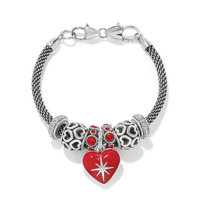 Brighton silver-plated charm bracelet with red enamel heart pendant, crystal beads, and heart-patterned charms on a white background