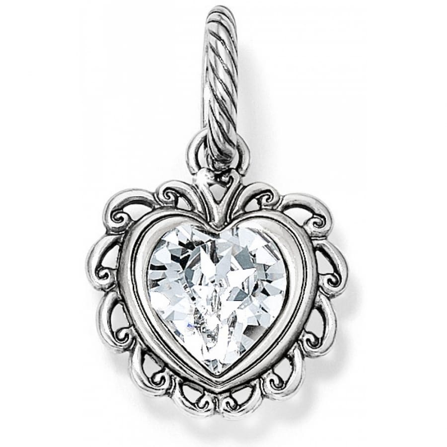 Brighton heart charm with faceted crystal center and silver-plated scrollwork frame with rope bail on a white background