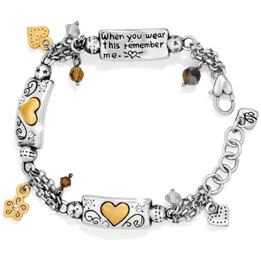 Brighton charm bracelet with silver-plated and brushed gold hearts, engraved message plaque, and crystal accents on a white background