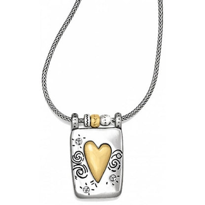 Brighton pendant necklace with brushed gold heart, silver-plated rectangular frame, and swirl engravings on a white background