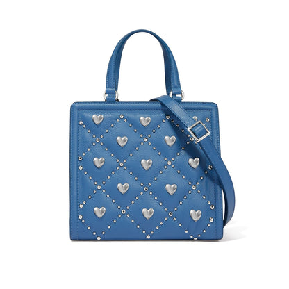 Brighton blue leather handbag with silver-tone heart studs, diamond bead pattern, and adjustable strap on a white background