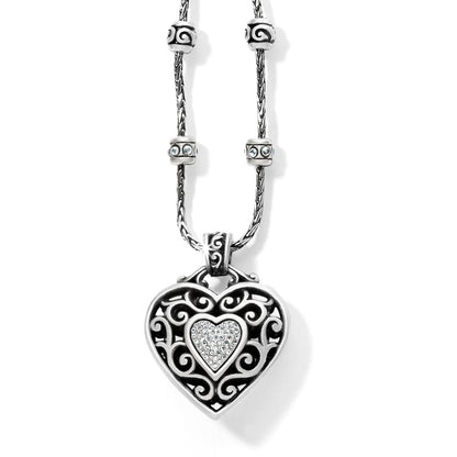 Brighton pendant necklace with silver-plated filigree heart, crystal center, and decorative beaded chain on a white background