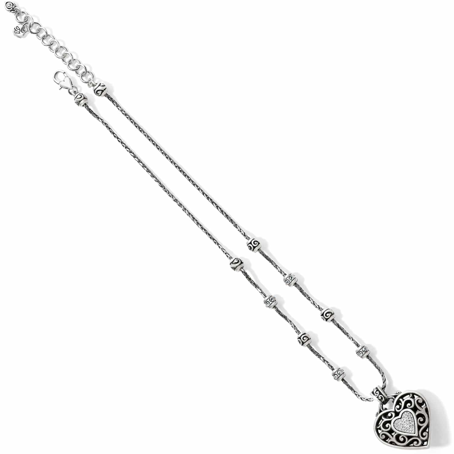 Brighton silver-plated pendant necklace with ornate scrollwork heart, crystal pavé accents, and beaded chain on a white background