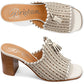 Brighton woven leather heeled slide sandals in cream with tassel detail and stacked wood block heel on a white background