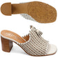 Brighton woven leather block heel mule sandals in white with tassel accent and patterned sole on a white background