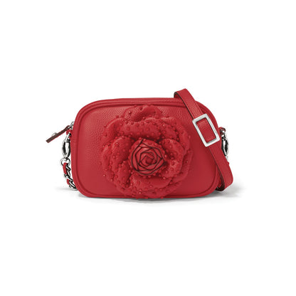 Brighton red leather crossbody handbag with large rosette flower appliqué and silver-tone adjustable strap on a white background