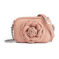 Brighton crossbody handbag in pink leather with rosette appliqué and silver-tone chain strap on a white background