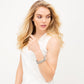 Model wearing Brighton silver-plated bangle bracelets with engraved textured detailing stacked on the wrist