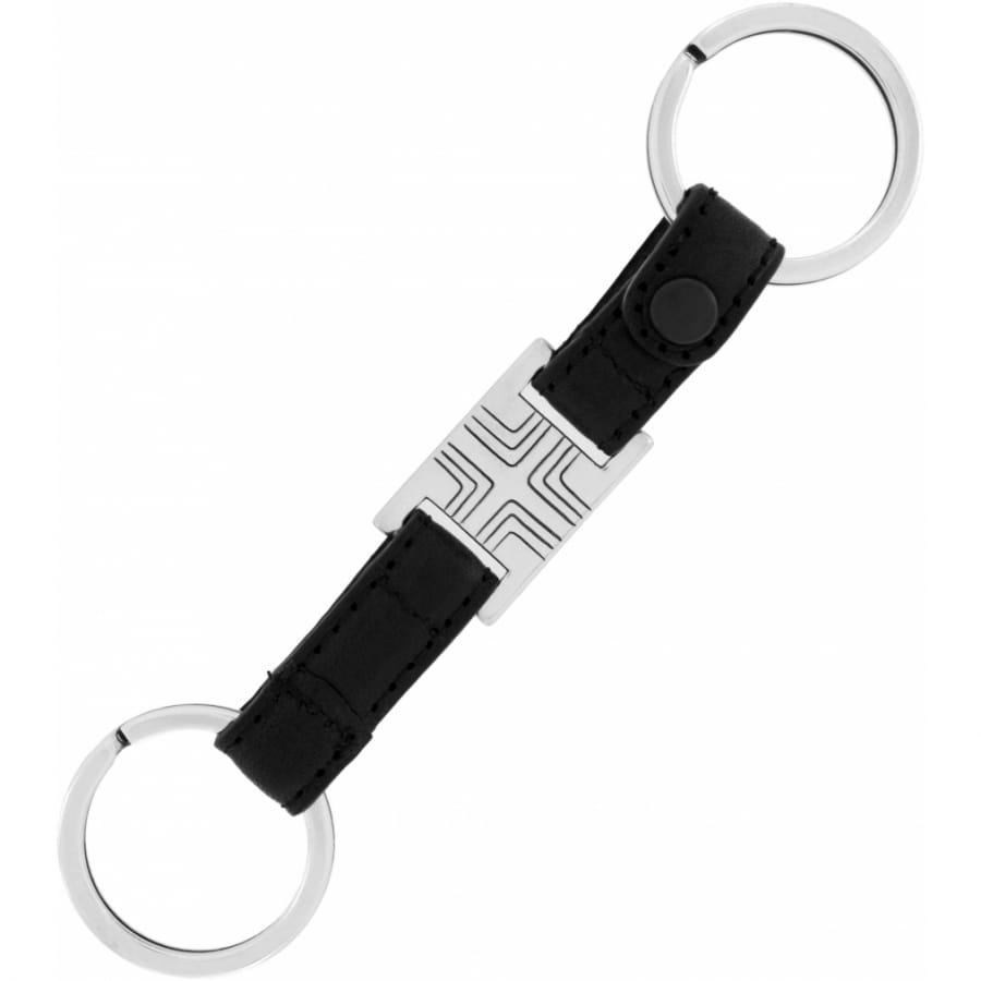Brighton key fob with black leather strap, silver-tone geometric center plaque, and dual split rings on a white background