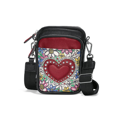 Brighton crossbody handbag with floral graphic print, red studded heart accent, and adjustable black strap on a white background