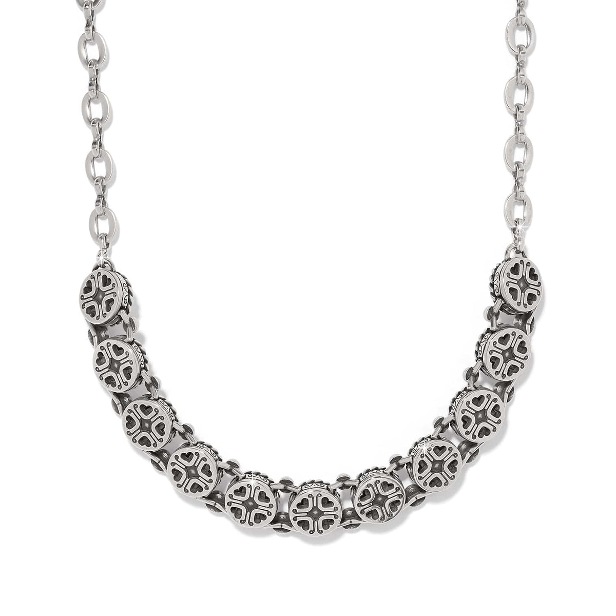 Brighton silver-plated necklace with row of ornate medallion links featuring heart cutout details on a white background