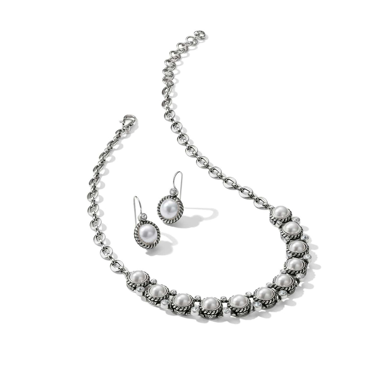 Brighton silver-plated necklace and drop earrings set with glass pearls and crystal accents on a white background