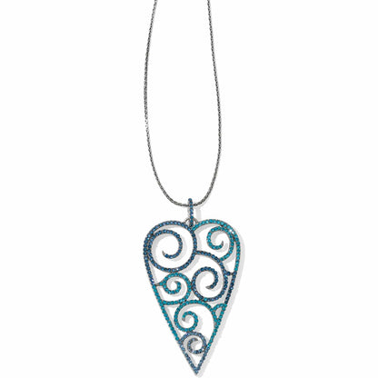 Brighton pendant necklace with blue crystal heart featuring swirl cutouts and silver-plated chain on a white background