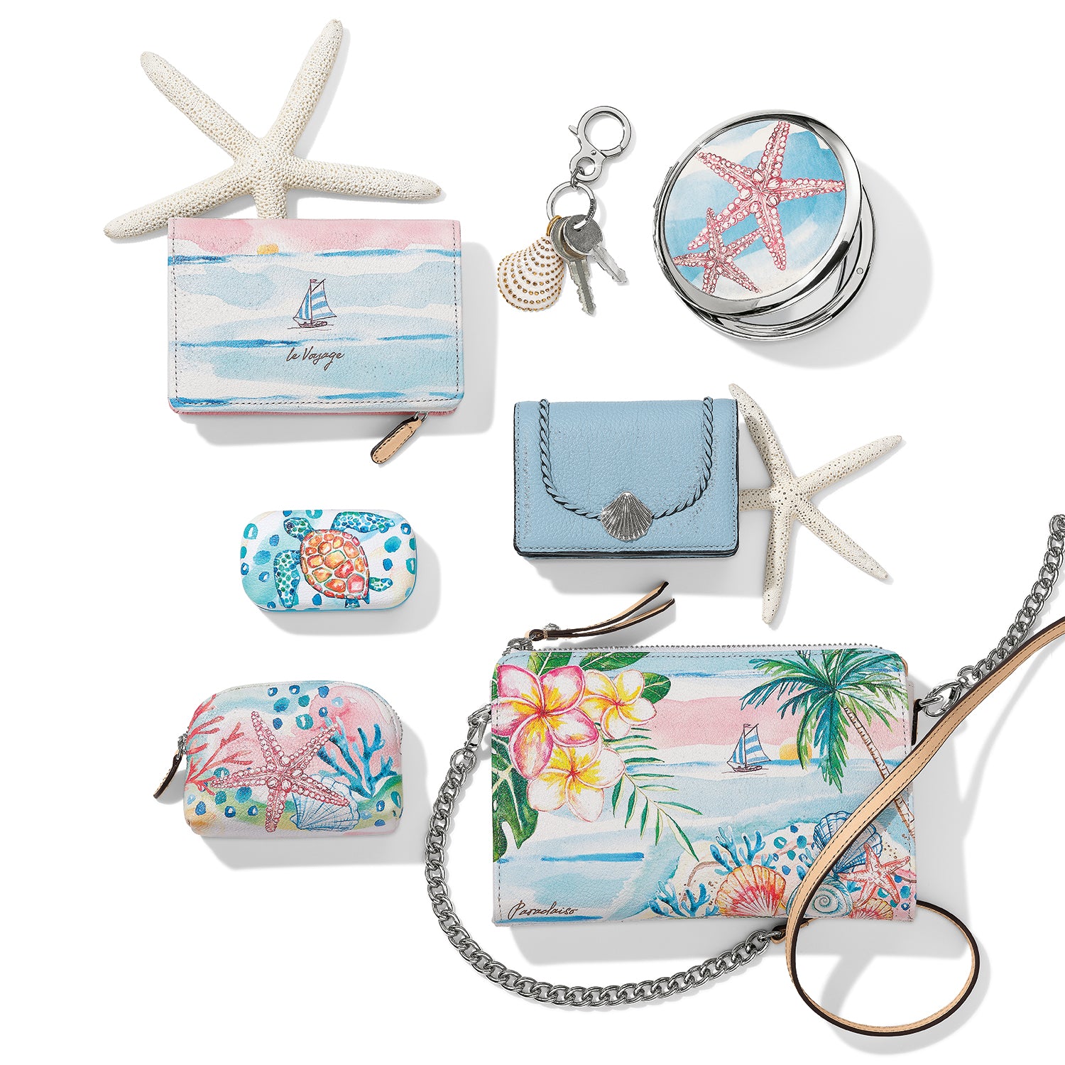 Brighton accessories styled with starfish and a set of keys, featuring tropical watercolor prints and coastal motifs