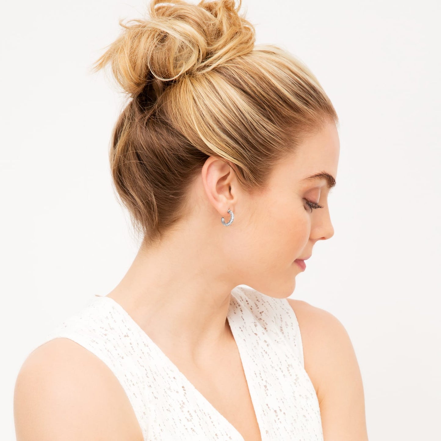 Model wearing a Brighton hoop earring with crystal accents and gold-plated finish shown in profile view