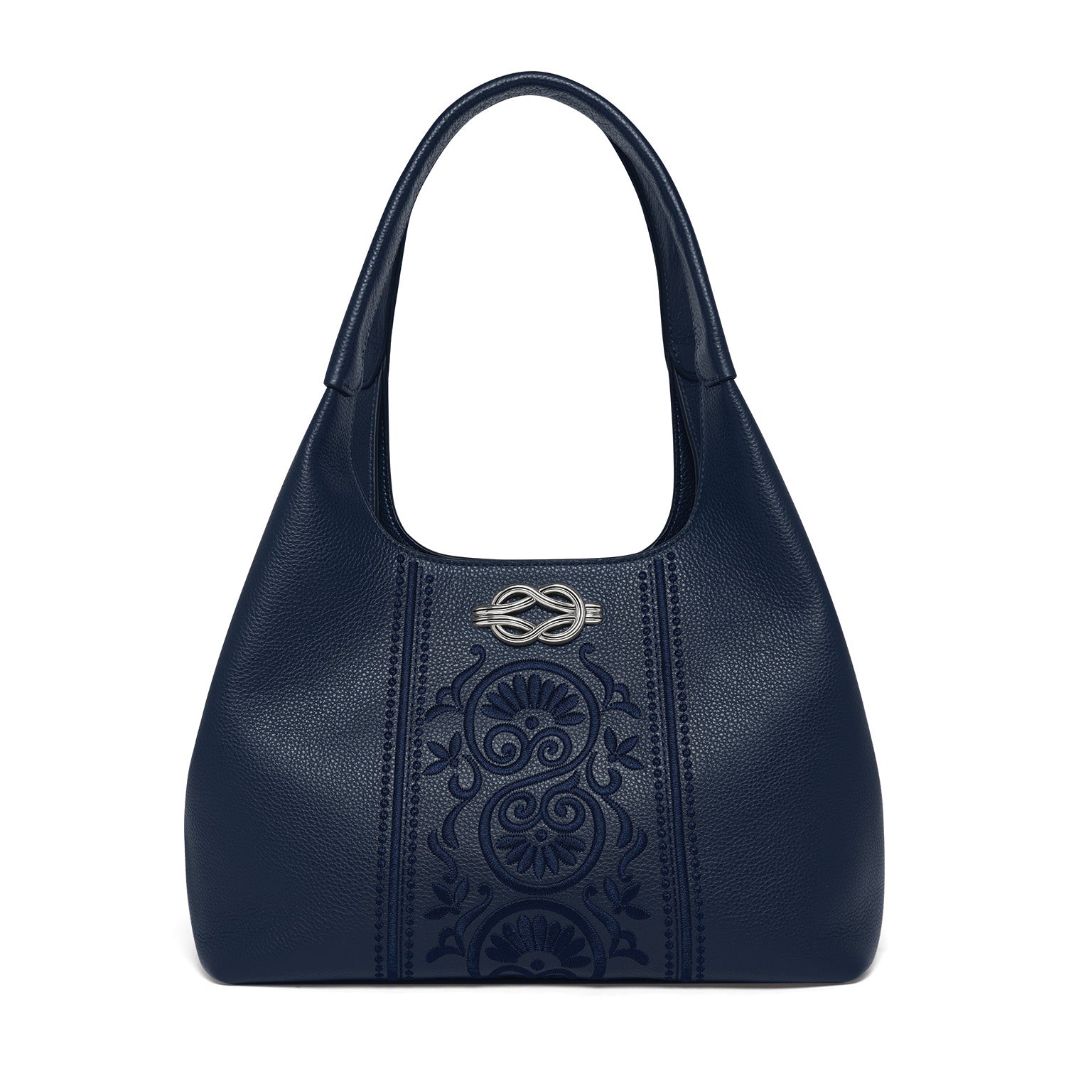 Brighton navy blue leather handbag with embossed floral panel and silver-tone knot emblem on a white background