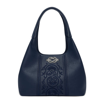 Brighton navy blue leather handbag with embossed floral panel and silver-tone knot emblem on a white background