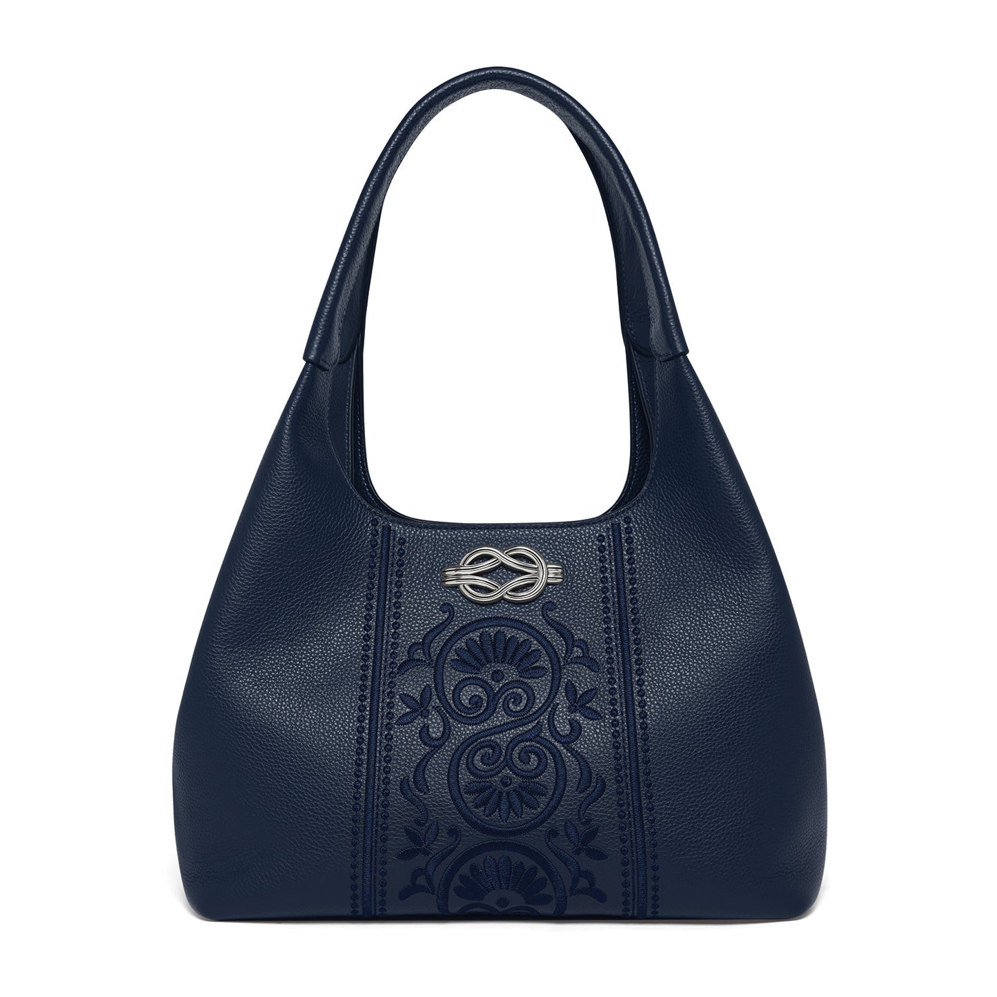 Brighton navy blue leather handbag with embossed floral panel and silver-tone knot emblem on a white background