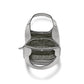 Brighton gray leather handbag shown open from above with patterned interior lining and zippered pocket on a white background