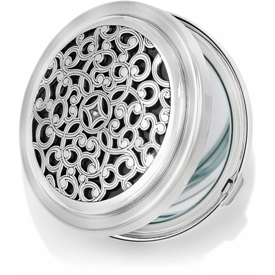 Brighton compact mirror with silver-tone scrollwork filigree design on hinged round case on a white background