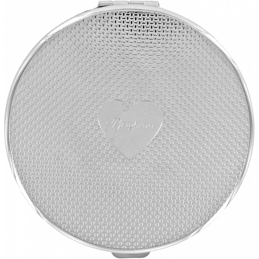 Brighton round silver-tone compact with woven texture pattern and engraved heart emblem at center on a white background