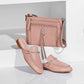 Brighton pink leather crossbody handbag styled with matching leather mules featuring silver-tone knot hardware on white background