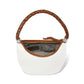 Brighton white leather handbag shown open with braided leather handle and patterned interior lining on a white background