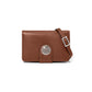 Brighton crossbody handbag in brown pebbled leather with silver-tone medallion accent and adjustable strap on a white background