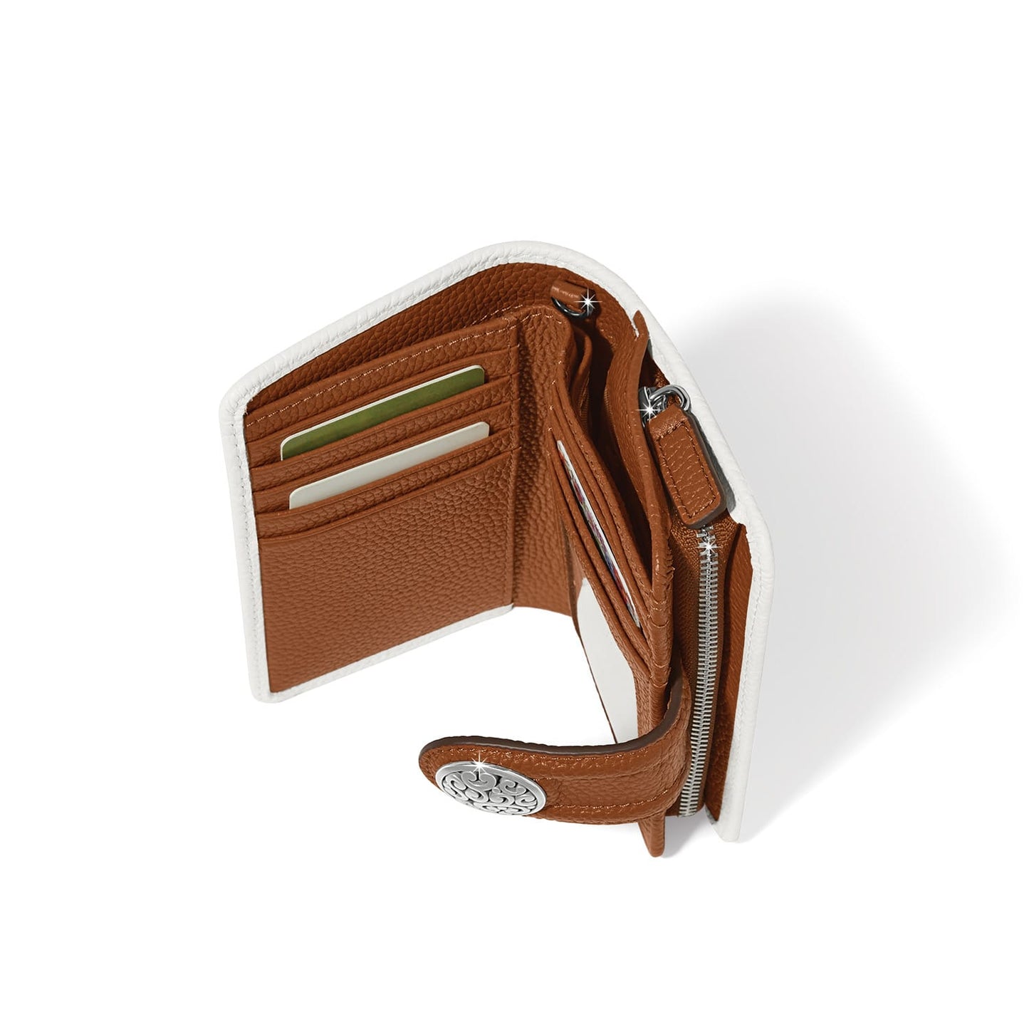 Brighton bifold wallet shown open with tan leather interior, card slots, zip pocket, and silver-tone medallion on a white background