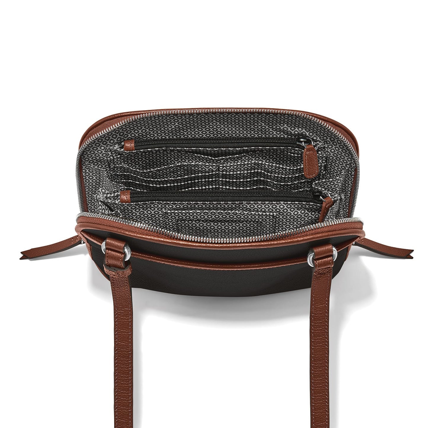 Close-up of Brighton handbag interior with patterned lining, zippered pockets, and brown leather trim