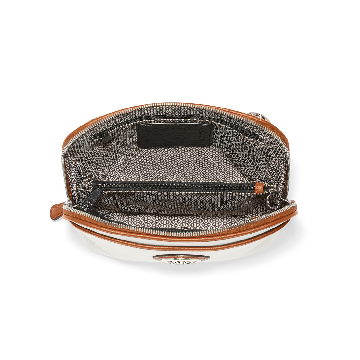 Close-up of Brighton handbag interior view showing patterned fabric lining, zippered pocket, and tan leather trim