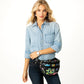 Model with a Brighton black belt bag featuring colorful graphic print, double zippers, and adjustable strap
