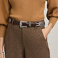 Model wearing a Brighton brown leather belt with ornate silver-tone engraved buckle, keeper, and tip