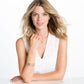 Model wearing a Brighton silver-plated crystal pendant necklace with coordinating crystal stud earrings and stacked bracelets