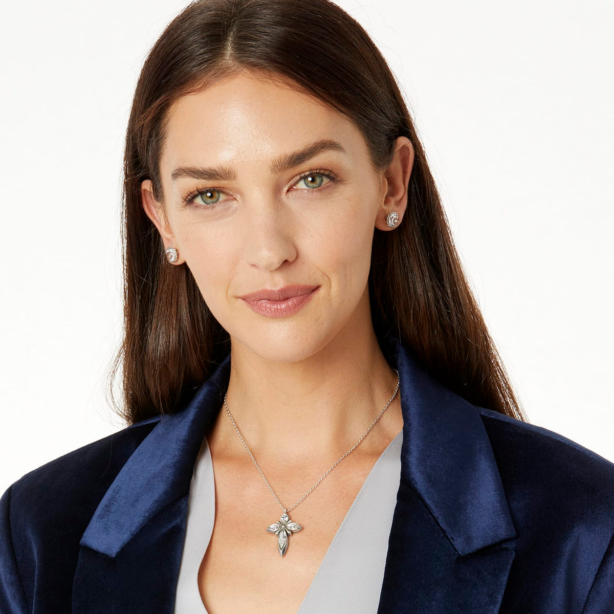 Model wearing a Brighton silver-plated cross pendant necklace with crystal accents paired with matching floral stud earrings
