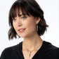 Model wearing a Brighton silver-plated drop necklace with crystal bar pendant paired with matching crystal drop earrings