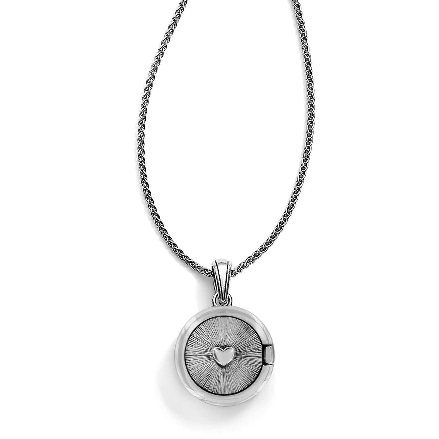 Brighton pendant necklace with round two-tone locket featuring sunburst engraving and raised heart center on a white background