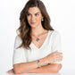 Model wearing a Brighton silver-plated pendant necklace with matching scroll-patterned earrings and coordinating Brighton accessories