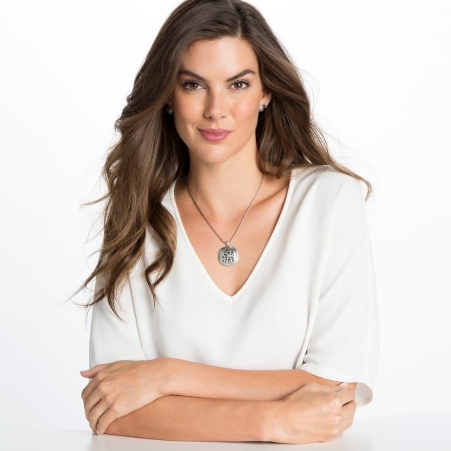 Model wearing a Brighton silver-plated pendant necklace with ornate openwork medallion and delicate chain
