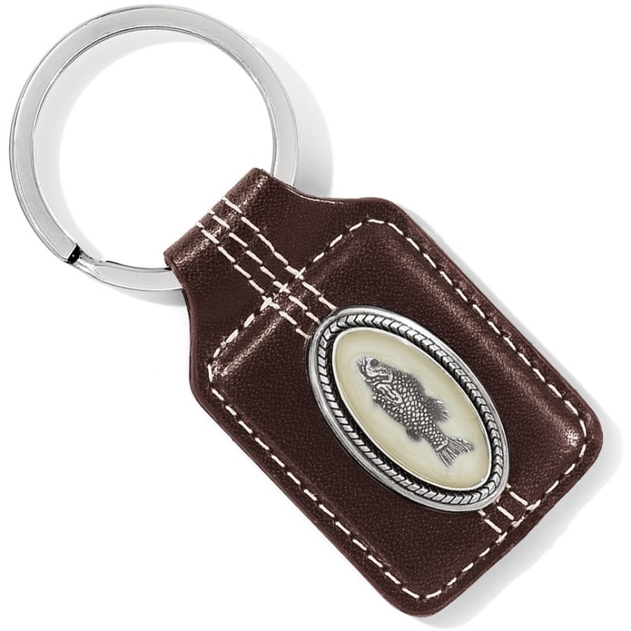Brighton key fob with brown leather body, stitched edges, oval silver-tone fish medallion, and split ring on a white background