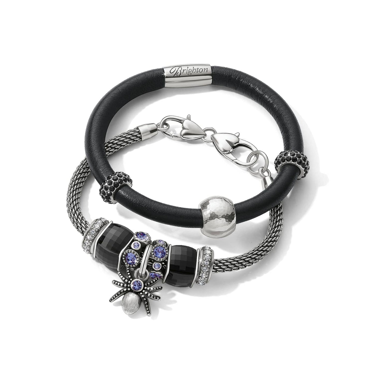 Brighton bracelets with black leather band, silver-plated mesh chain, crystal charms, and spider pendant on a white background