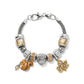 Brighton charm bracelet with enamel squirrel, silver-plated acorn, gold-tone maple leaf, and crystal beads on white background