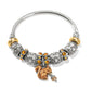 Brighton silver-plated bangle bracelet with ornate beads, amber crystals, and enamel squirrel charm on a white background