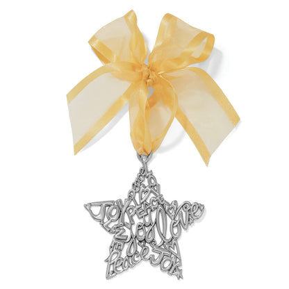 Brighton silver-plated star ornament with Joy Peace Love cutout lettering and sheer gold ribbon bow on a white background